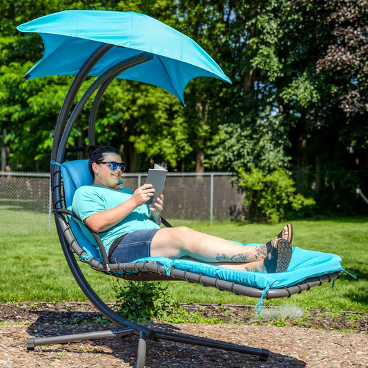 Curved steel hammock lounge chair with cushions and pillows